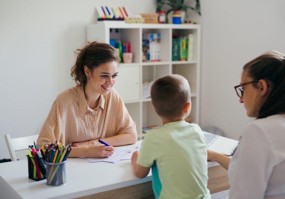 Psychologist evaluates a young child Psychologist evaluates a young child